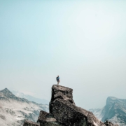 Image of a man standing on top of a mountain