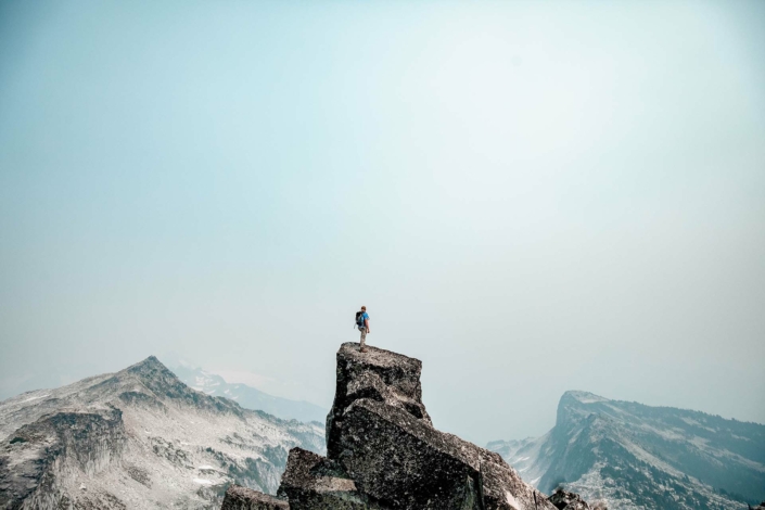 Image of a man standing on top of a mountain