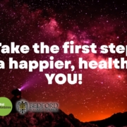 An image of a man on a mountain looking at text that says take the first step to a healthier, happier you