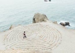 Image of a person navigating a maze on a beach