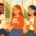 A cartoon image of people sitting at a window in autumn chatting and having coffee